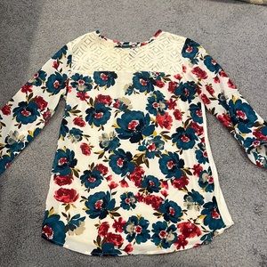 Floral printed blouse with lace embellishment on the top